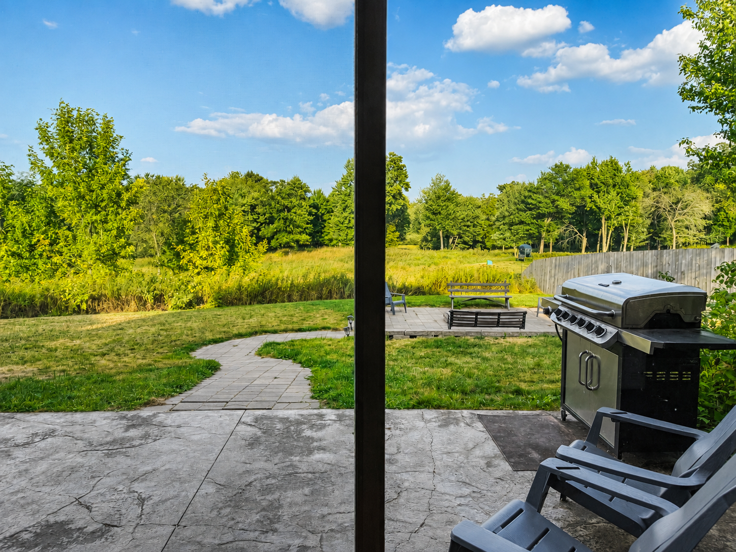 Step outside to the patio and grill area with peaceful views of the surrounding Northwoods property, perfect for cooking outdoors, relaxing in the fresh air, and enjoying your Wisconsin getaway.