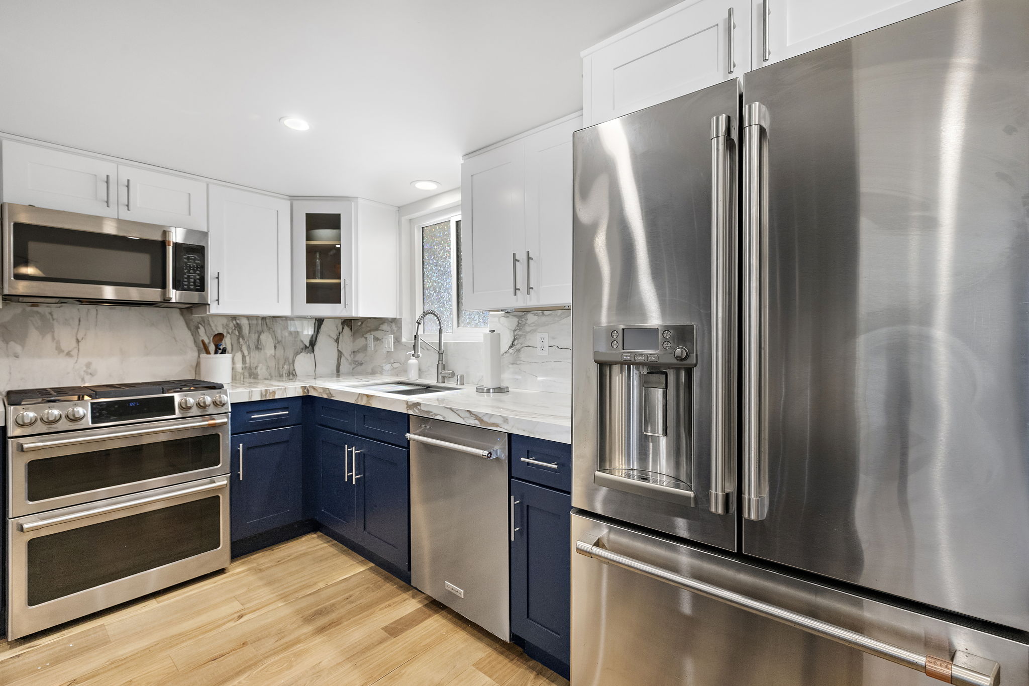 Full kitchen view highlighting premium stainless appliances, generous counter space, ample storage, and a functional layout that makes cooking easy and comfortable