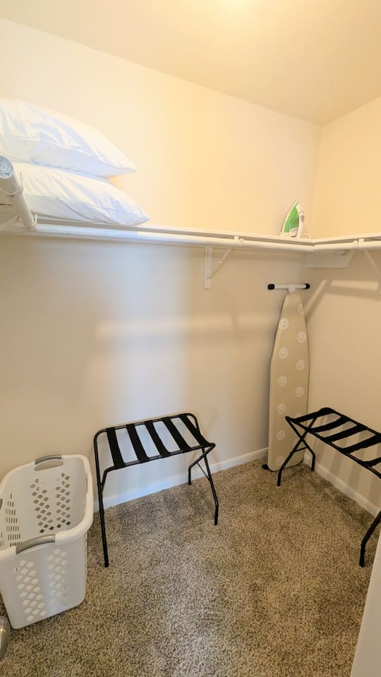 Large walk-in closet includes: 
* iron and full size ironing board
* two luggage racks
* laundry hamper
* hangers
* extra pillows and bedding 
