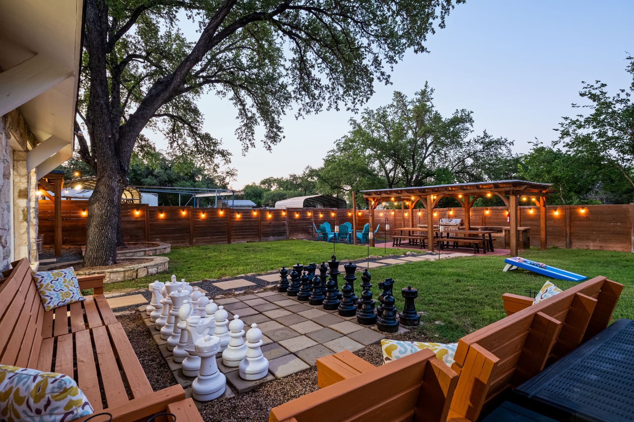 Challenge friends to a life-sized chess match, fire up the grill, or gather under the glow of string lights as the evening winds down. This backyard was designed for connection, laughter, and unforgettable nights outdoors.