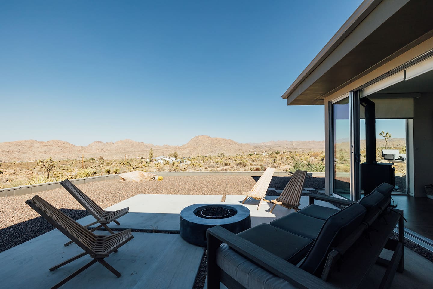 Gather on the side patio with cozy seating and a fire pit — the perfect spot for stargazing or late-night conversations under the desert sky.