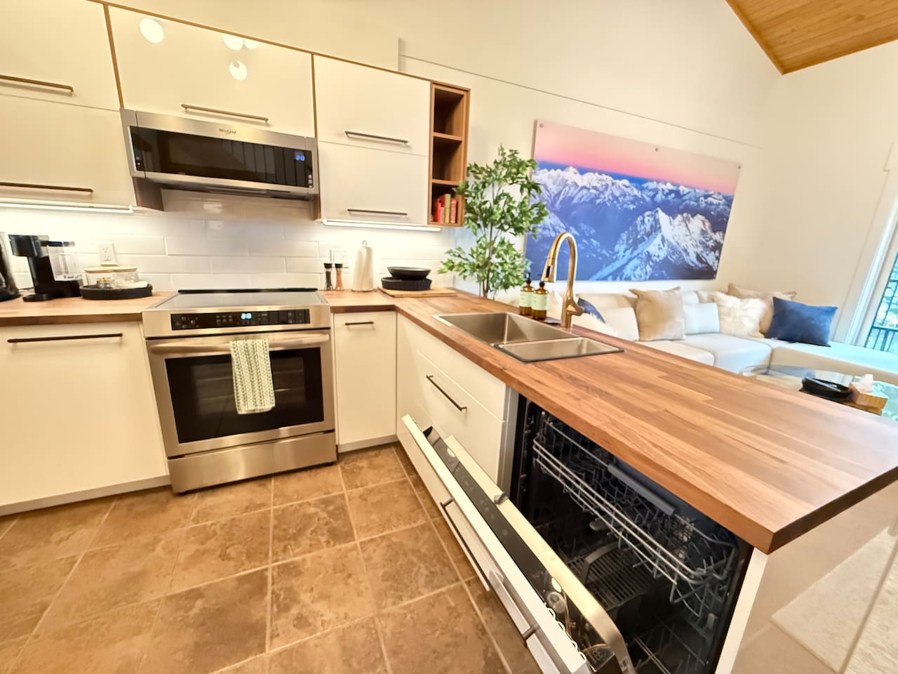 Efficient Layout: Enjoy this thoughtfully designed kitchen with a new built-in dishwasher, new microwave, and extensive countertop space for easy cooking and entertaining.