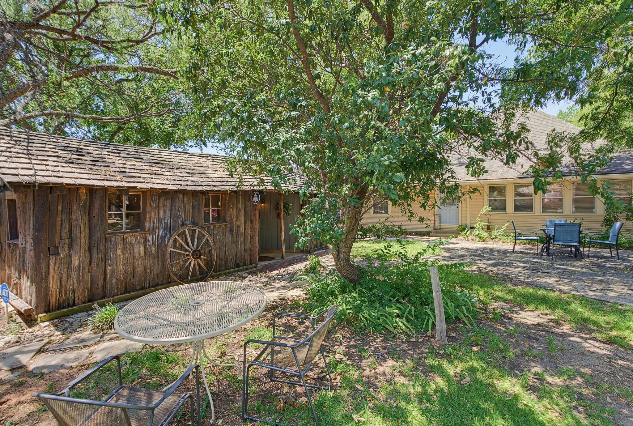 This is a separate building with a private entrance and covered parking off the alley. The patio area is shared with The Webb House.