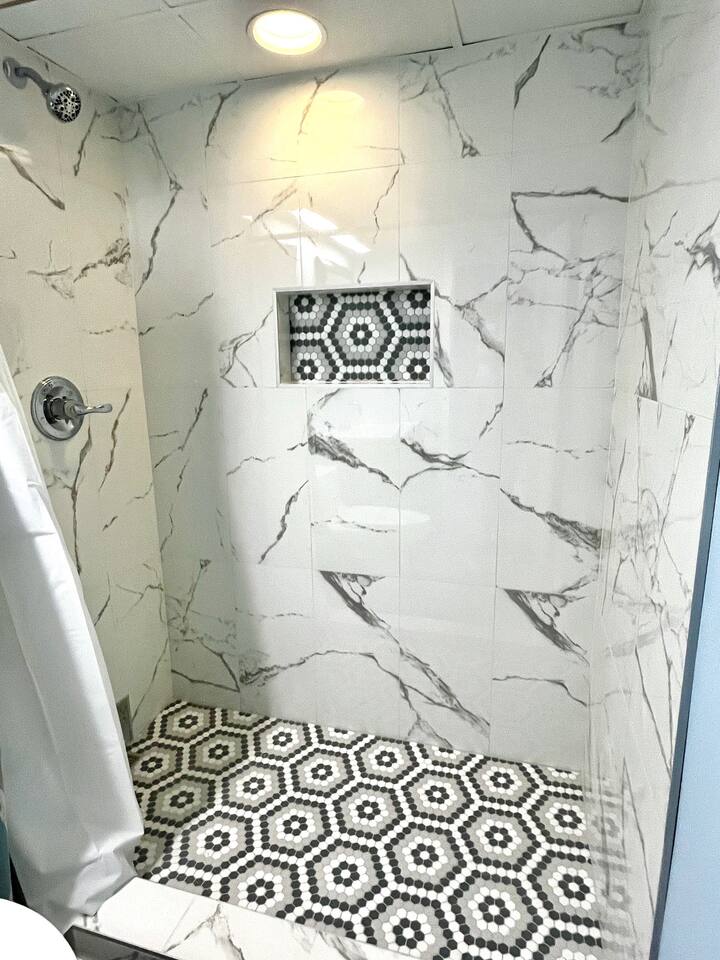 Step-in tiled shower in master bath. Shower is oversized for comfort.