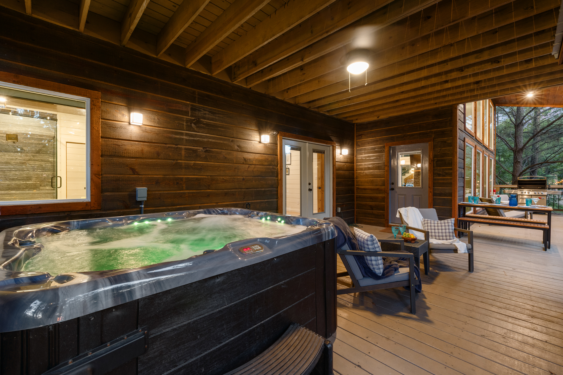 An open-air hangout built for comfort and connection — complete with a spacious dining setup, relaxed seating areas, a hot tub, fire feature, and outdoor TV for laid-back evenings under the sky. 🌙