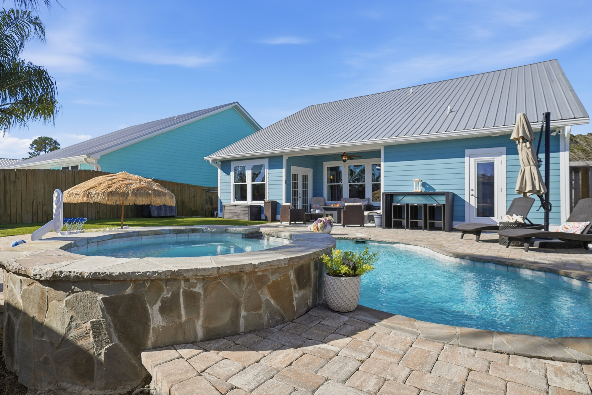 Spacious fenced backyard with a private pool, spa and outdoor living area.