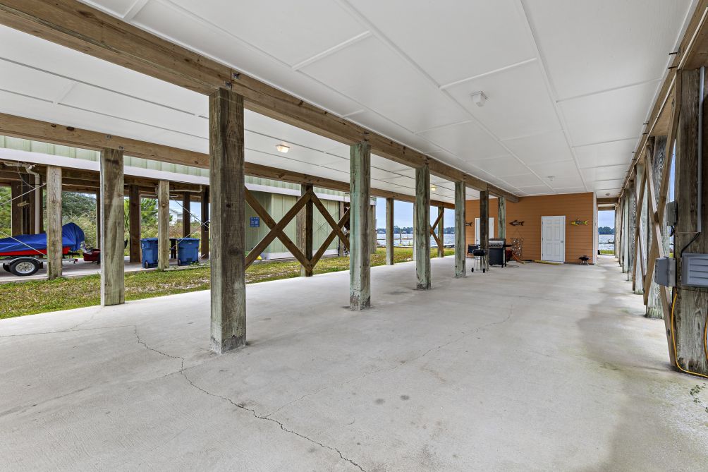 Covered parking area beneath the house