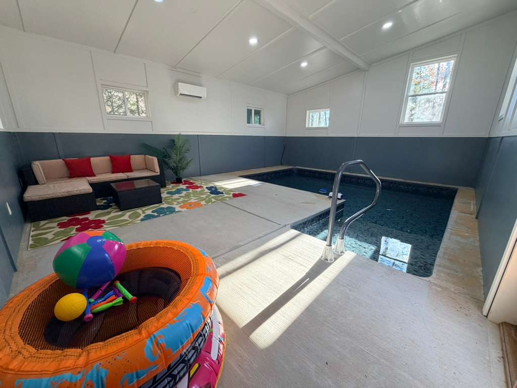Swim, splash, and lounge! Our private indoor pool area features comfortable seating, pool toys, and a vibrant rug for fun.