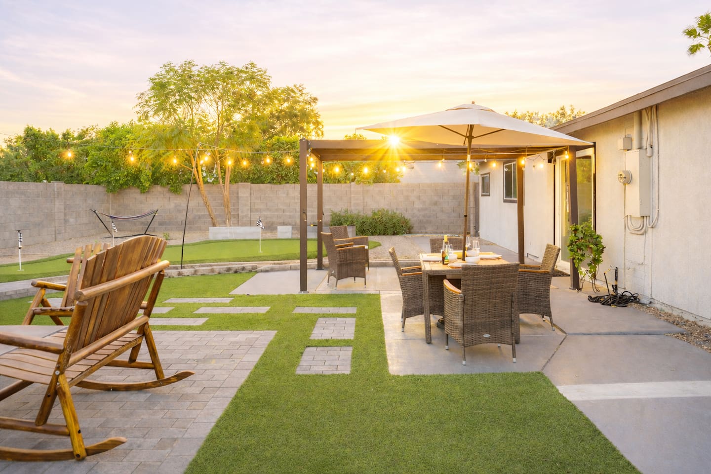 Golden hour in your private Scottsdale retreat—putting green, outdoor dining, and space designed for connection, laughter, and unforgettable nights