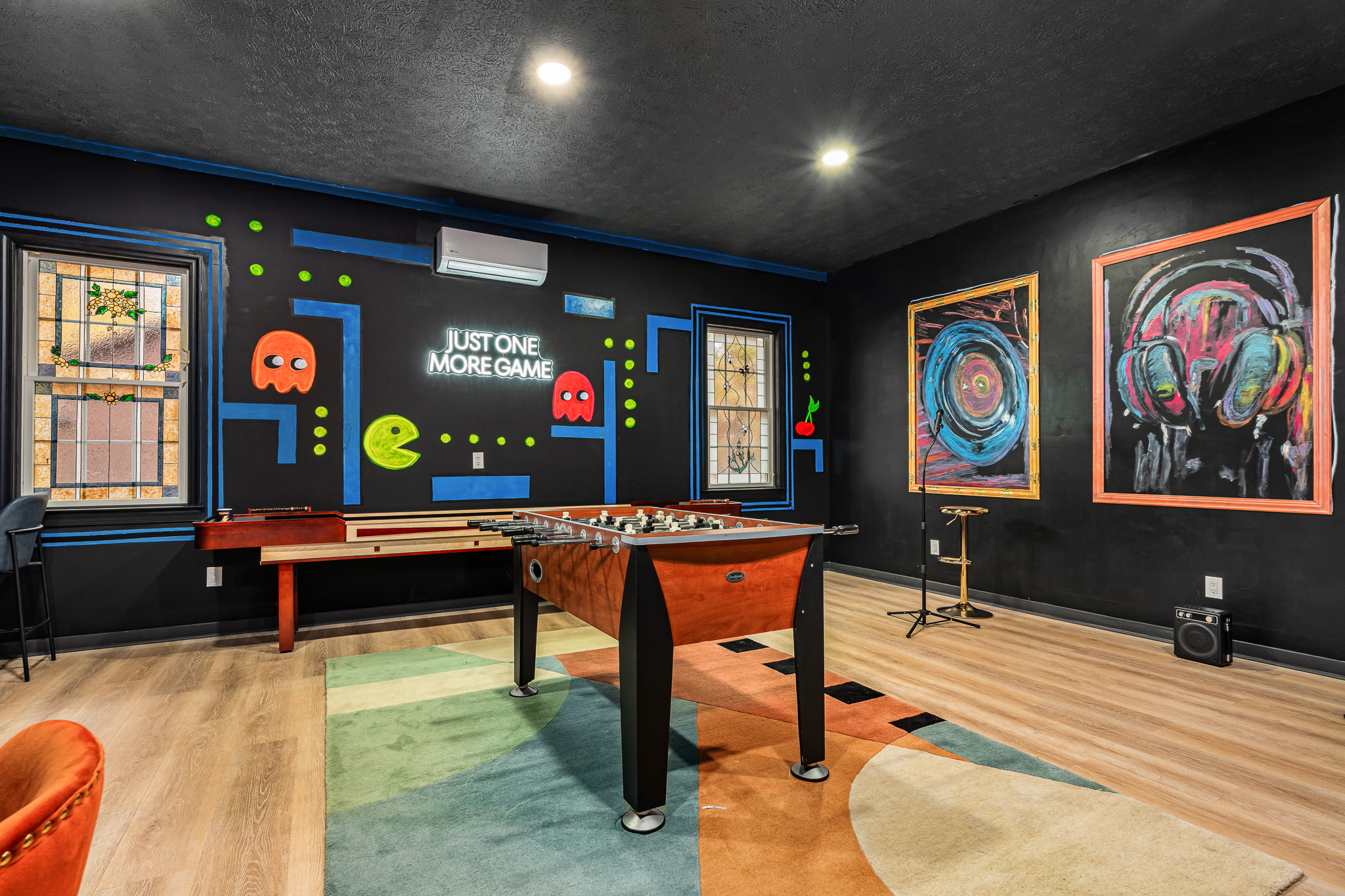 Arcade-night energy with shuffleboard, Pac-Man art, and endless games for all ages