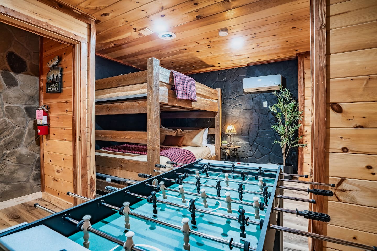 Fun-filled mountain cabin entertainment space with foosball, board games, and a playful atmosphere for memorable group vacations.