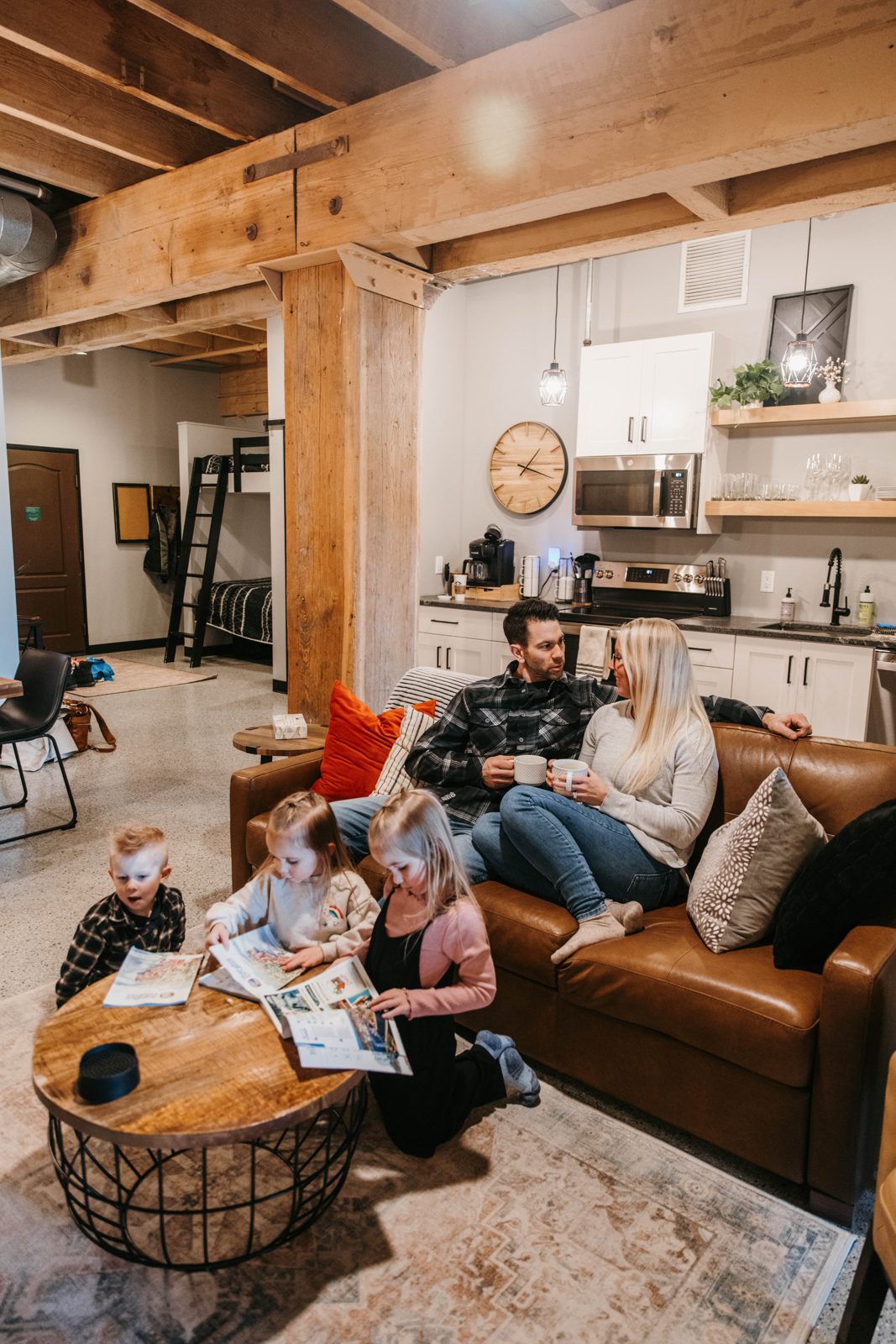 A family with kids relaxing together on a sectional in a Brix condo in Canal Park