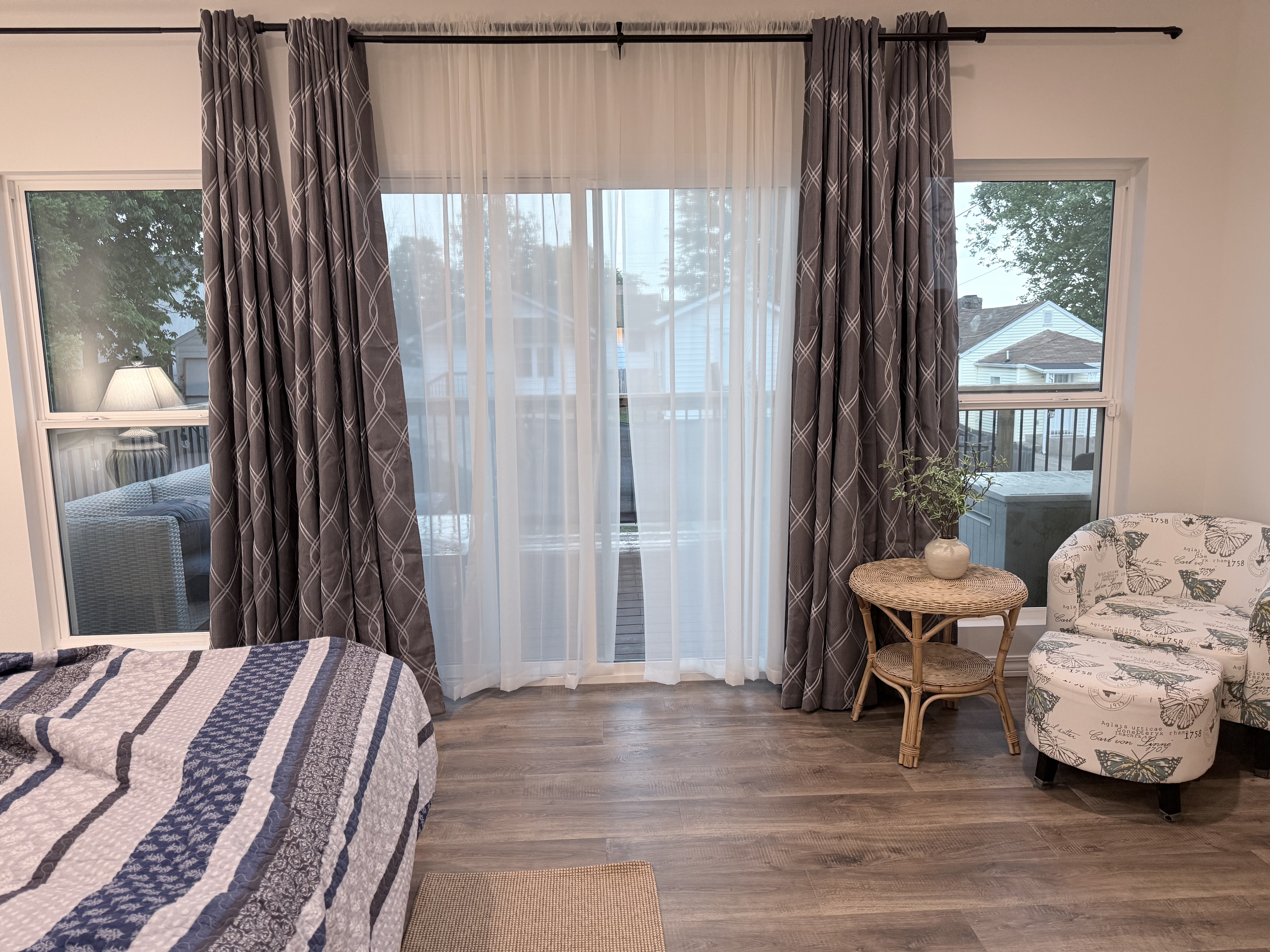 View of large glass windows in master bedroom leading to 10 by 25' composite deck with view of downtown,