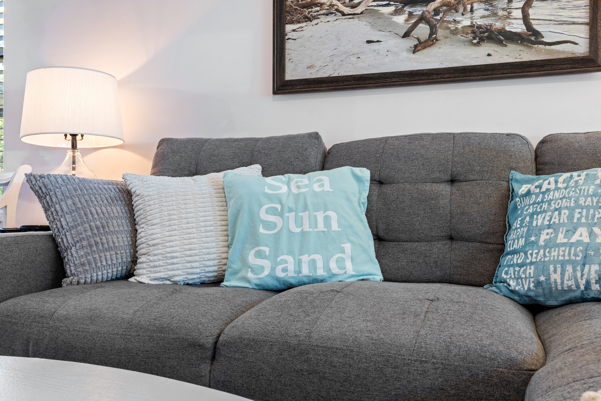 Relax in this comfy living space with a beachy vibe and modern decor.