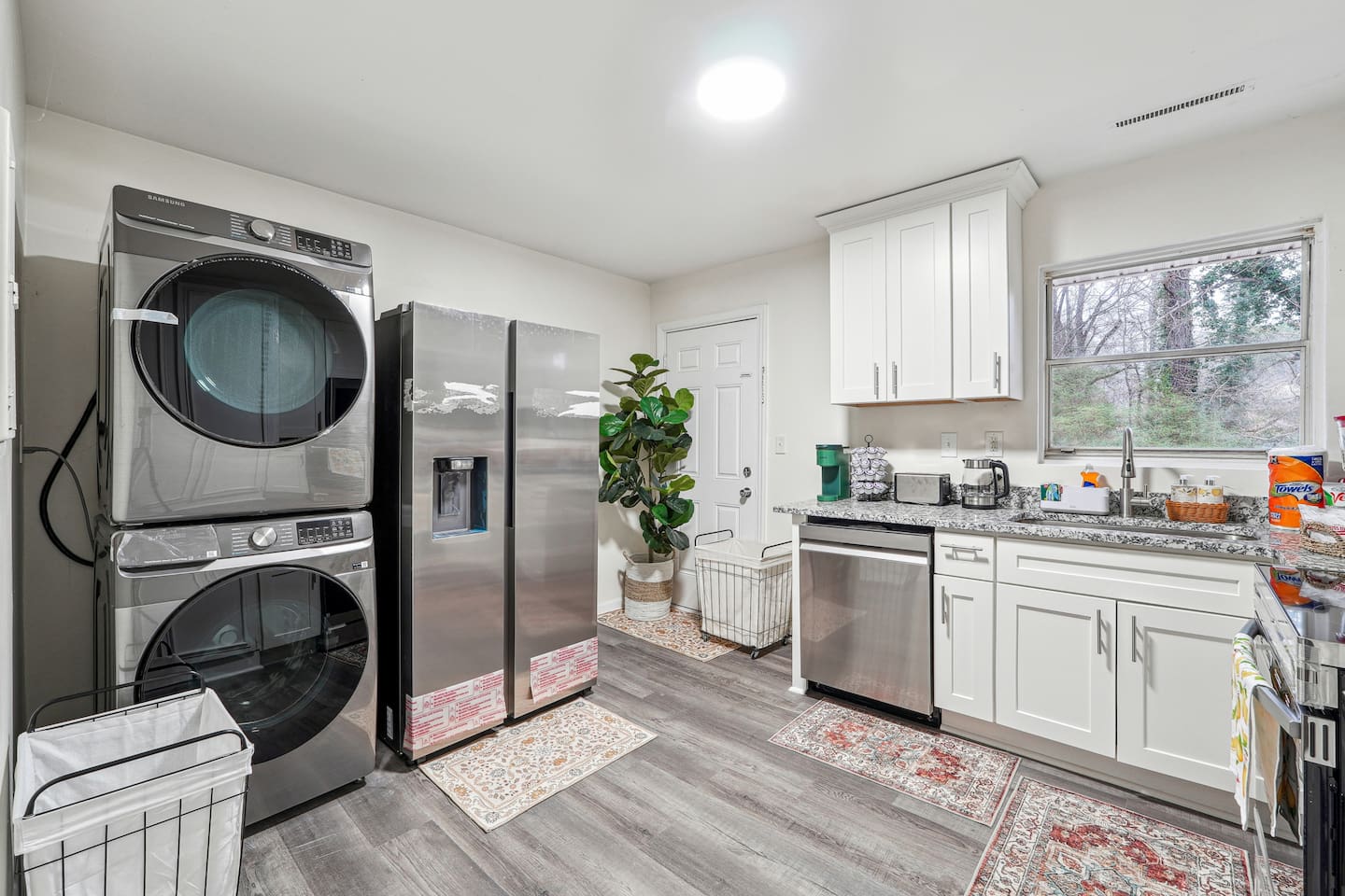 A convenient laundry area near the kitchen equipped with a washer, dryer, and laundry essentials like detergent and softener — perfect for guests who wish to do laundry during their stay.
