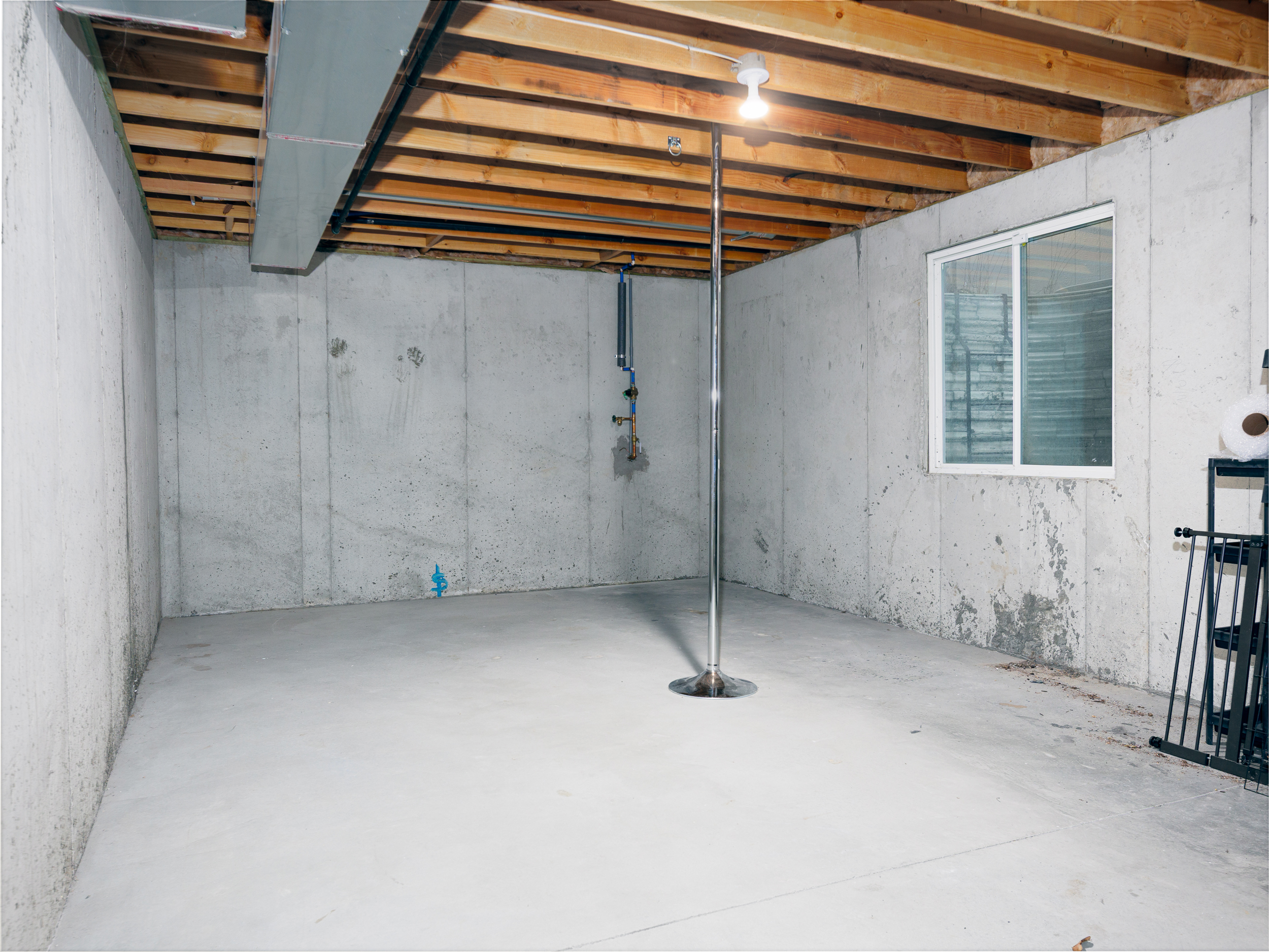 Lower-level unfinished basement providing additional storage space