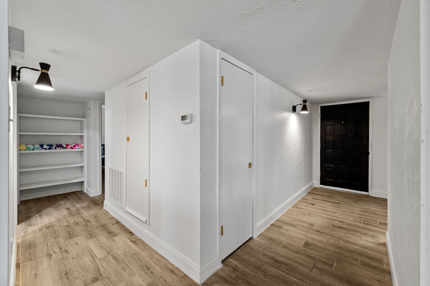 Clean, wide hallway with modern finishes that connect the home’s stylish layout.