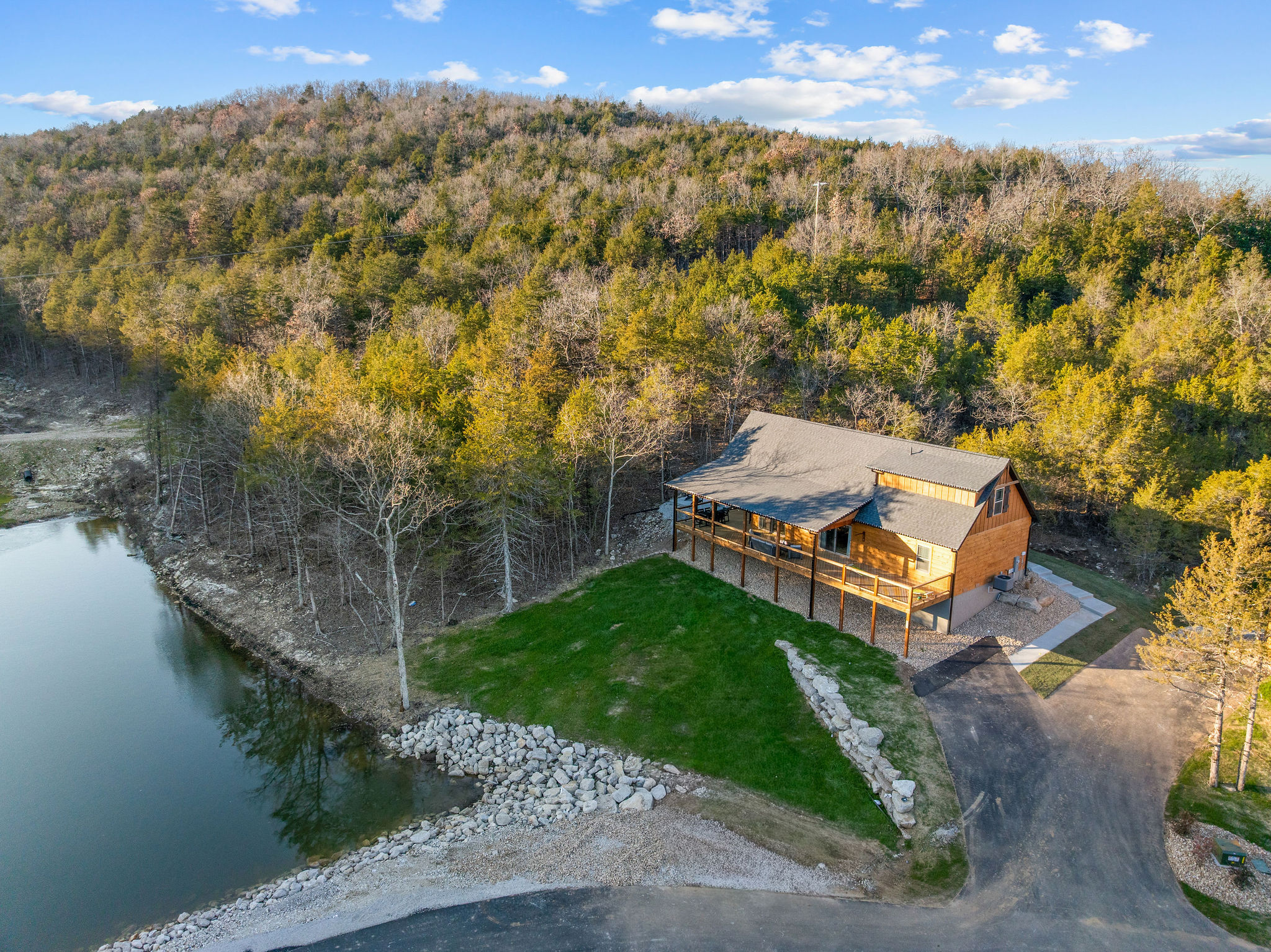 The cabin tucked near the water’s edge and wooded shoreline.