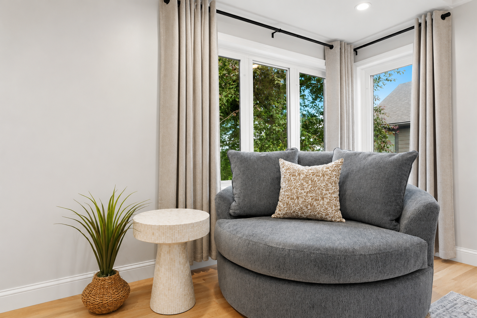 Cozy sitting nook with a plush chair, large windows, and natural light throughout. A calm, inviting corner perfect for reading, relaxing, or enjoying peaceful views.