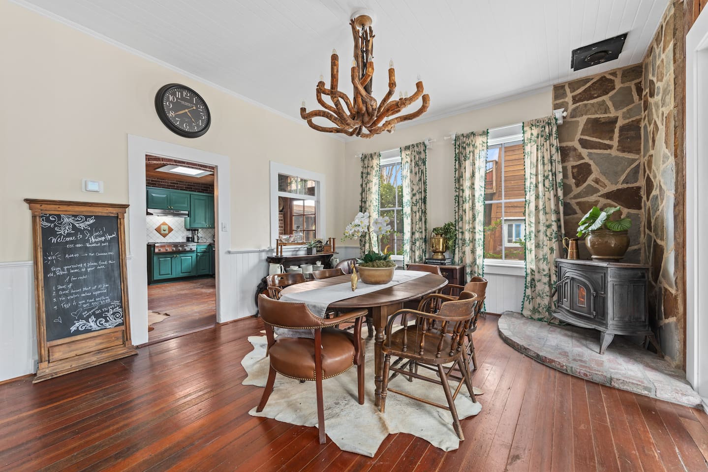 Light-filled dining room with sculptural French-driftwood chandelier opens to side patio for indoor / outdoor dining, and enjoying the amazing Central Coast weather. 