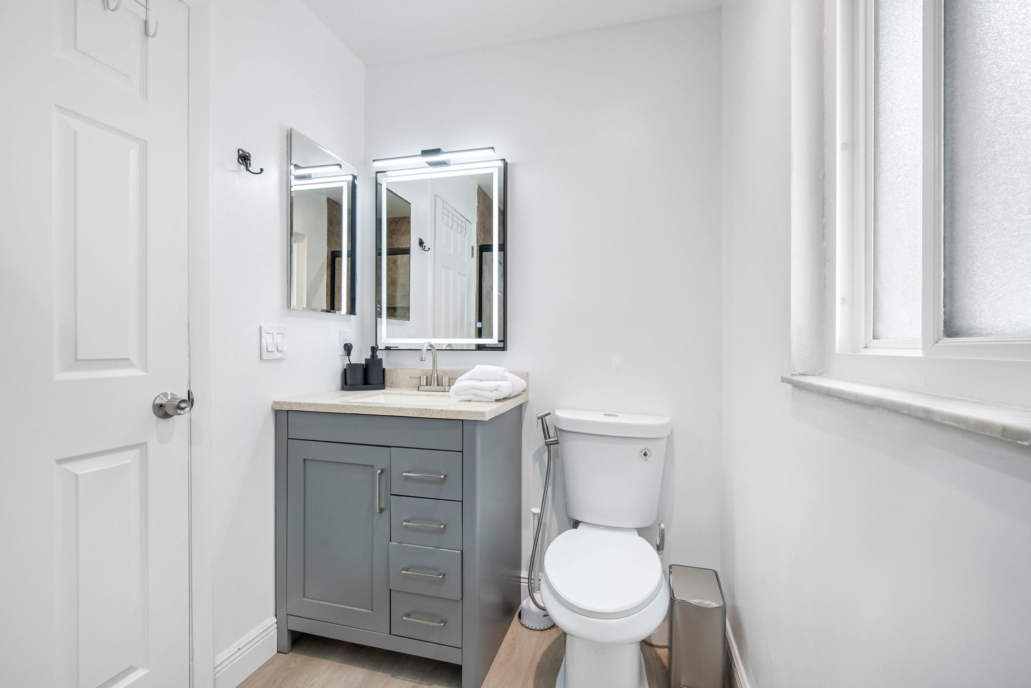 A bold backlit vanity light makes morning prep and evening wind-down routines feel special.