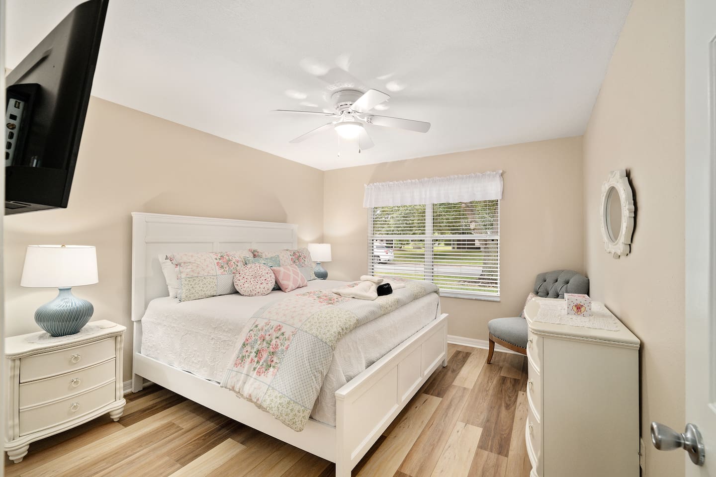 This charming bedroom features soft and elegant touches, warm natural light and classic decor.