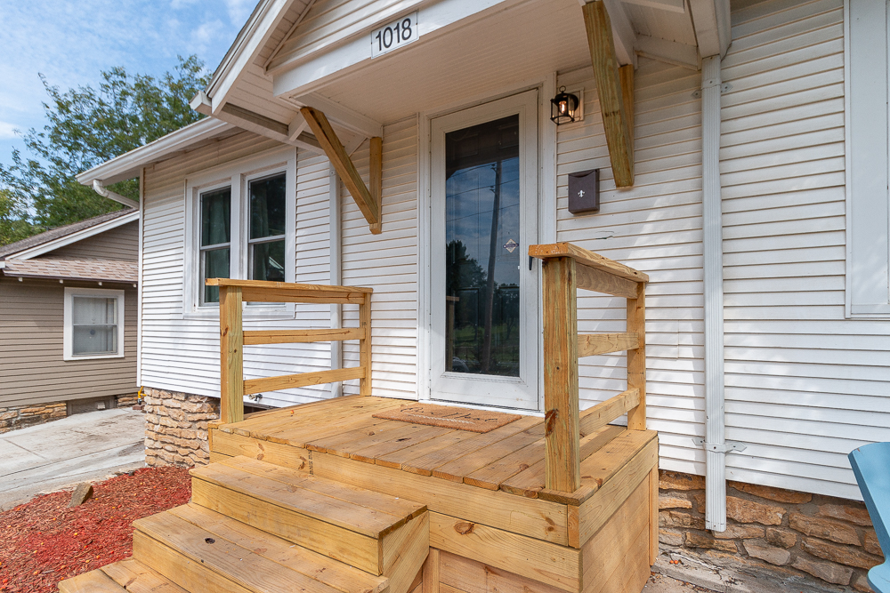 Charming exterior with fresh landscaping and inviting front porch.
