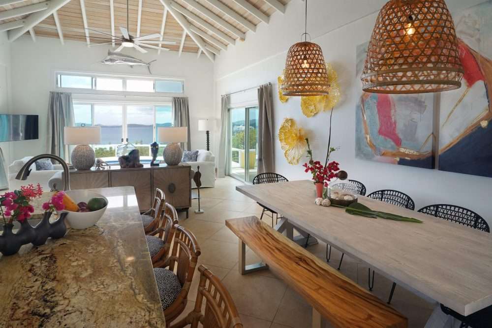 Enter the front doors into the kitchen which opens to the living room and incredible views