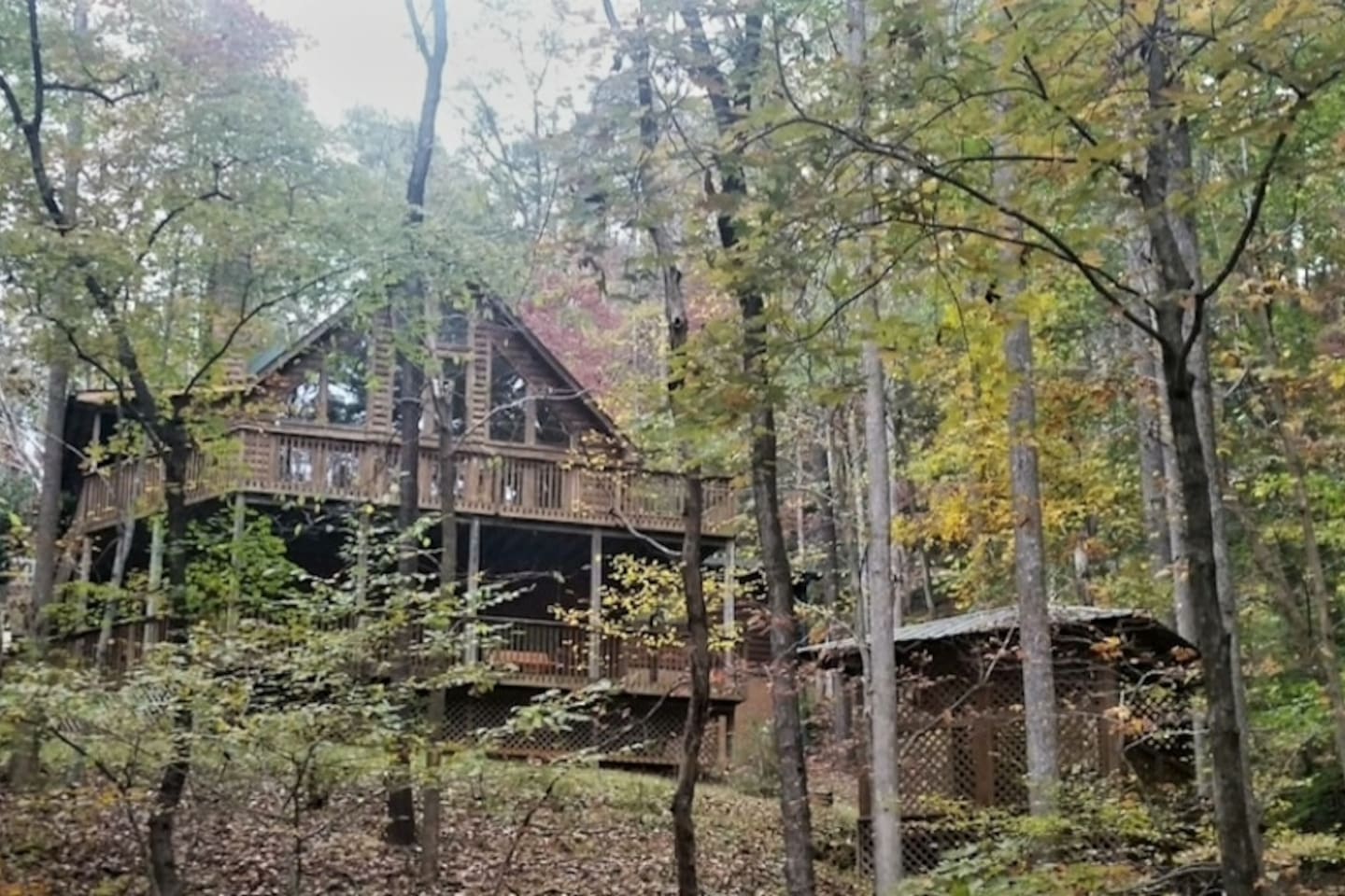 Back yard view with pavilion and steps down to walk to beach/lake/river.
