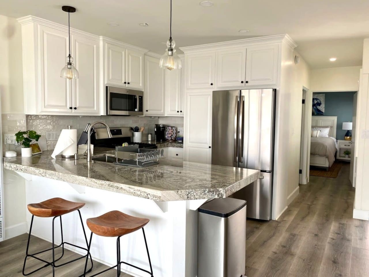 Walking back through the kitchen is the bathroom on the right and the bedroom at the end of the hall.