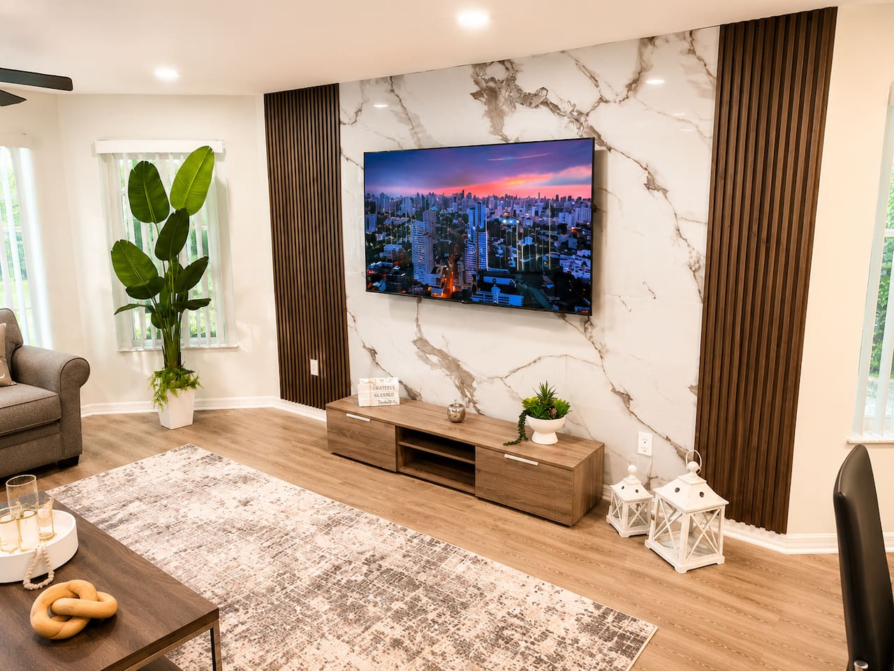 Stylish entertainment wall with a TV and marble-inspired finishes.