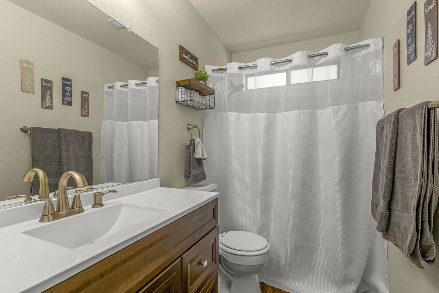 Bathroom with practical storage, fresh towels, and everything needed for simple daily routines.