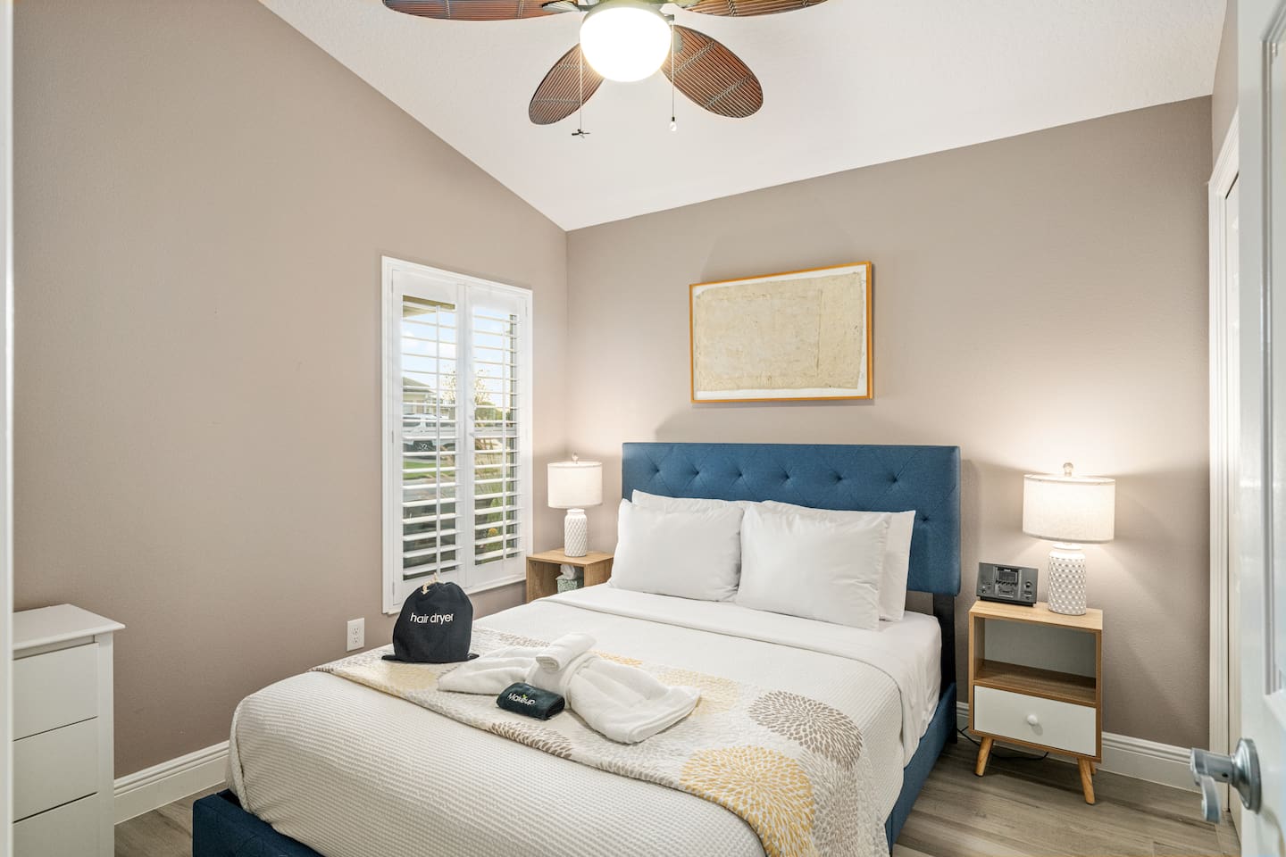 The guest bedroom features a comfortable queen bed and a closet for clothing storage.  