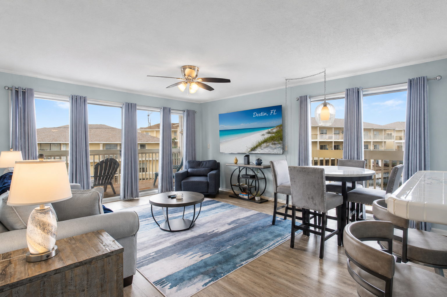 Bring the outside in! Our main living area opens up to dynamic views from both the small and large balconies, filling the condo with natural light and coastal vibes.