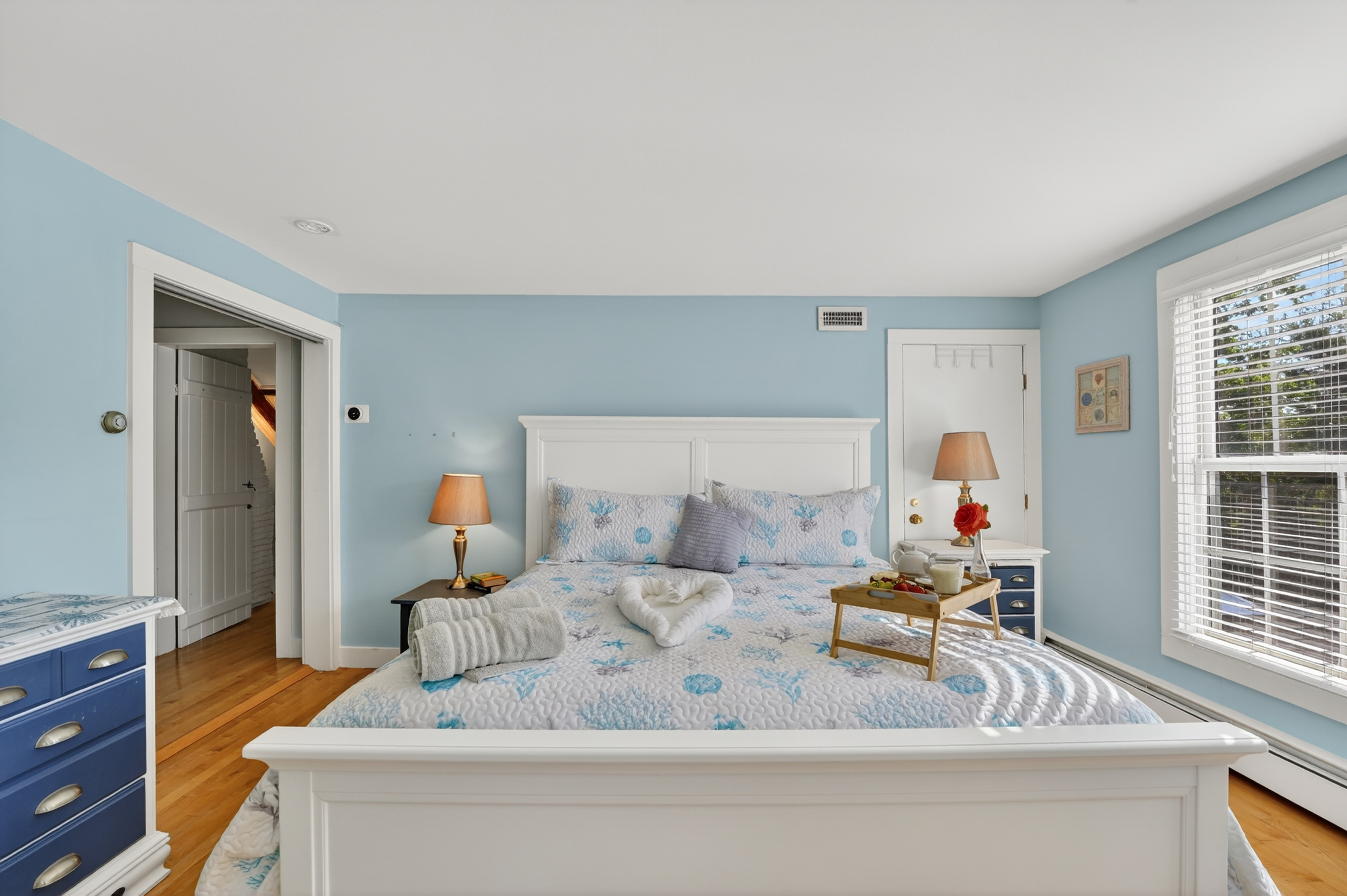 Bright and airy bedroom with comfortable furnishings and plenty of space to relax.