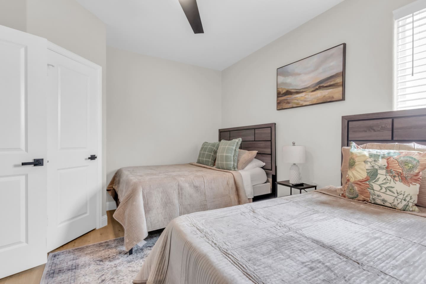 Double Queen bedroom with clean design and cozy bedding.