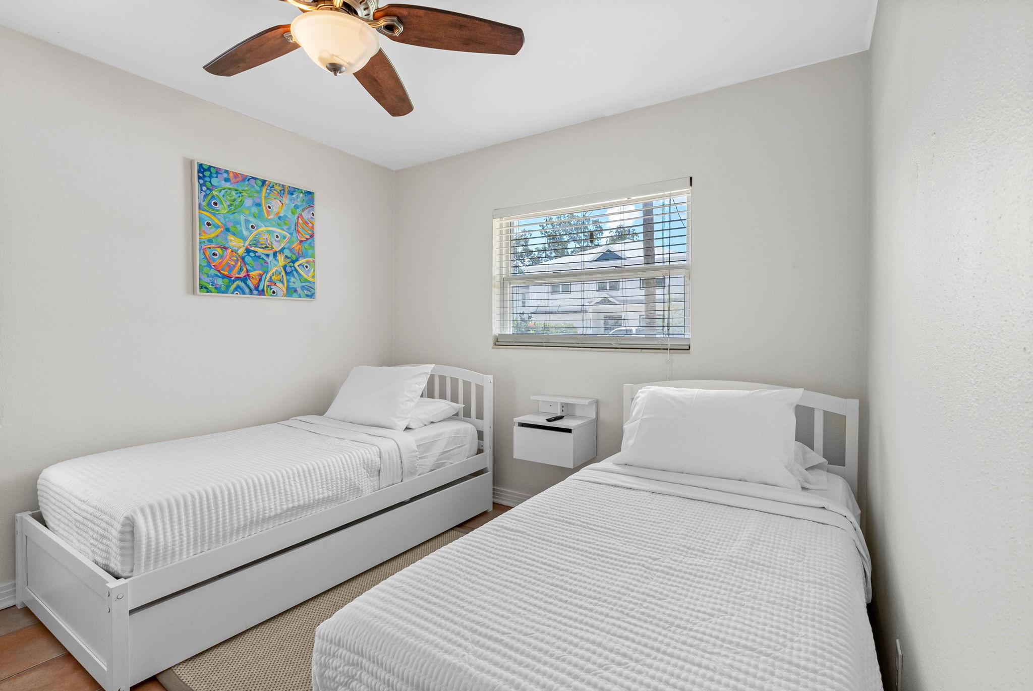 This cheerful, sunlit bedroom is thoughtfully arranged to offer comfort, flexibility, and functionality—ideal for siblings, friends traveling together, or additional guests who prefer separate beds.