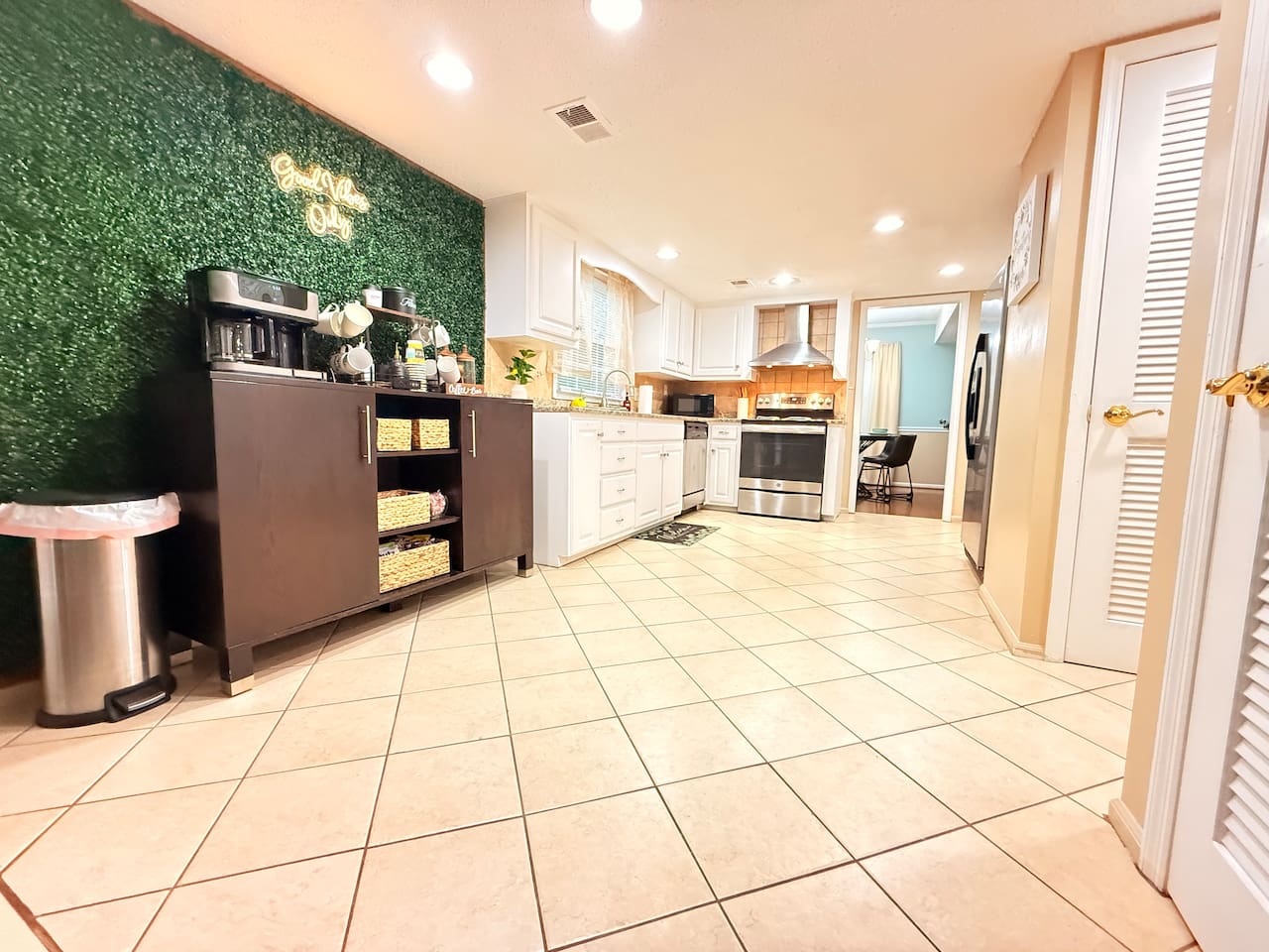 Full view of the kitchen and coffee station, showing open flow, ample lighting, and all essentials for extended stays.