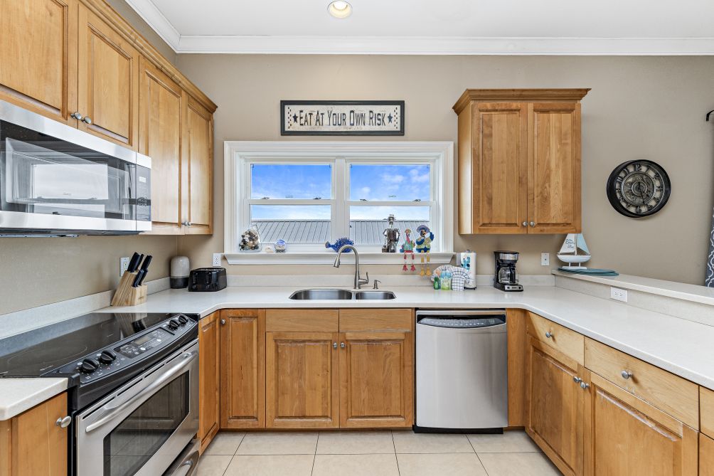 Fully equipped kitchen with stainless steel appliances, gas range, and ample counter space