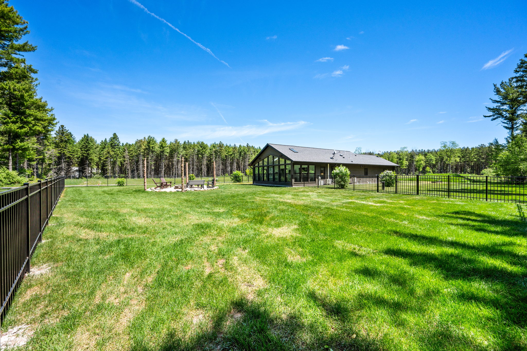 This private wooded property offers wide-open green space, a cozy fire pit, and a secluded setting perfect for relaxing in nature.
