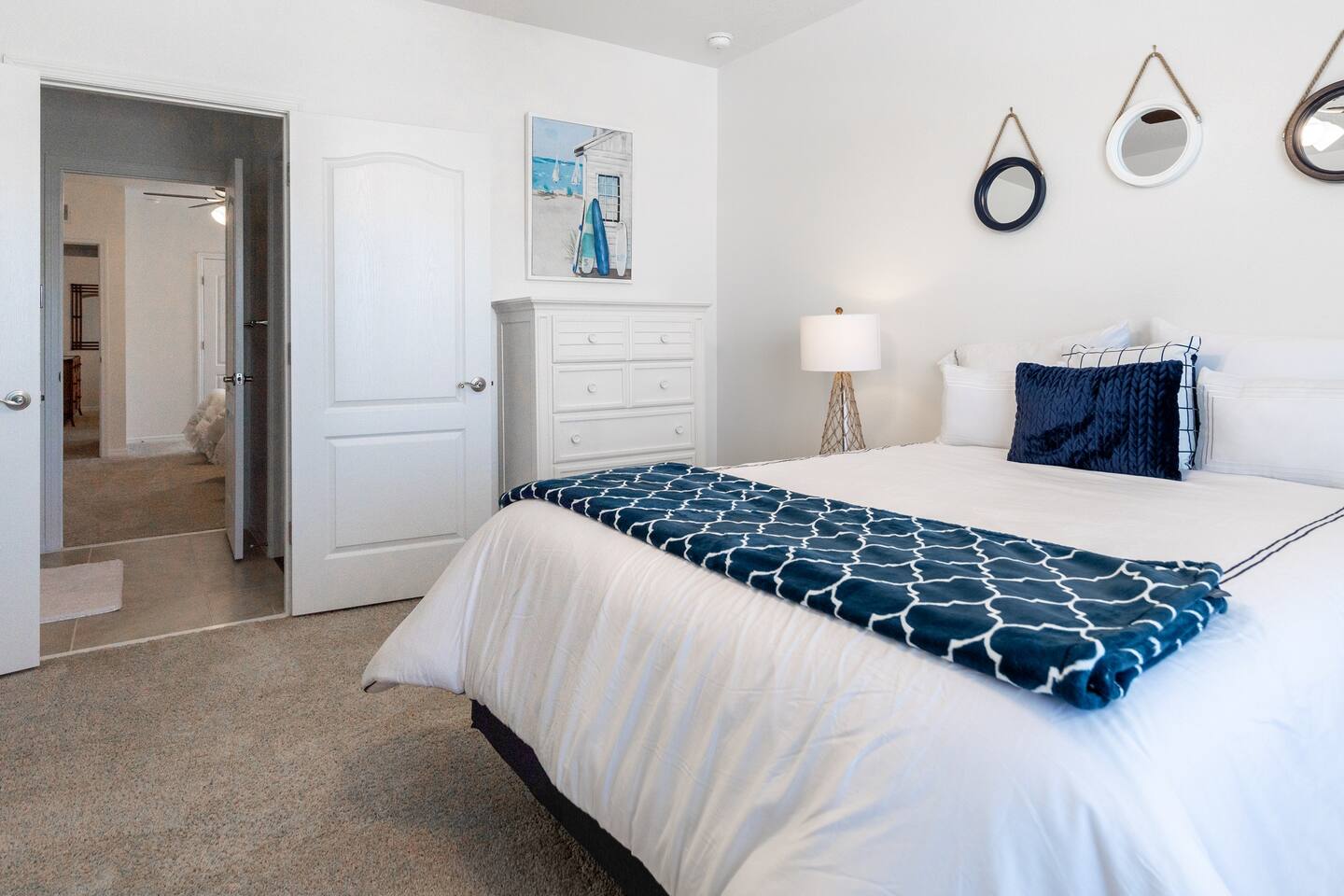 Upstairs Nautical Themed Room with Queen Bed.  Includes a 70 inch smart TV.  Luggage rack & laundry basket in closet.