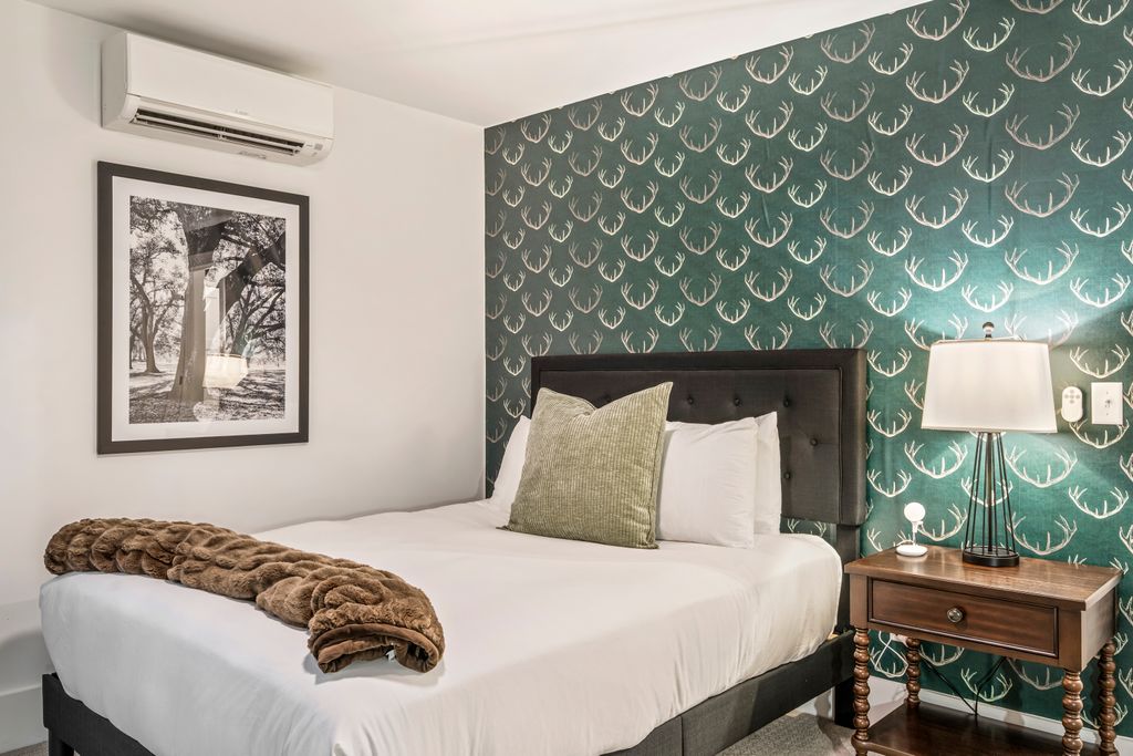 A modern mountain retreat with cozy bedding, thoughtful design, and peaceful forest views — perfect for guests seeking comfort and calm after a day exploring Bethel.