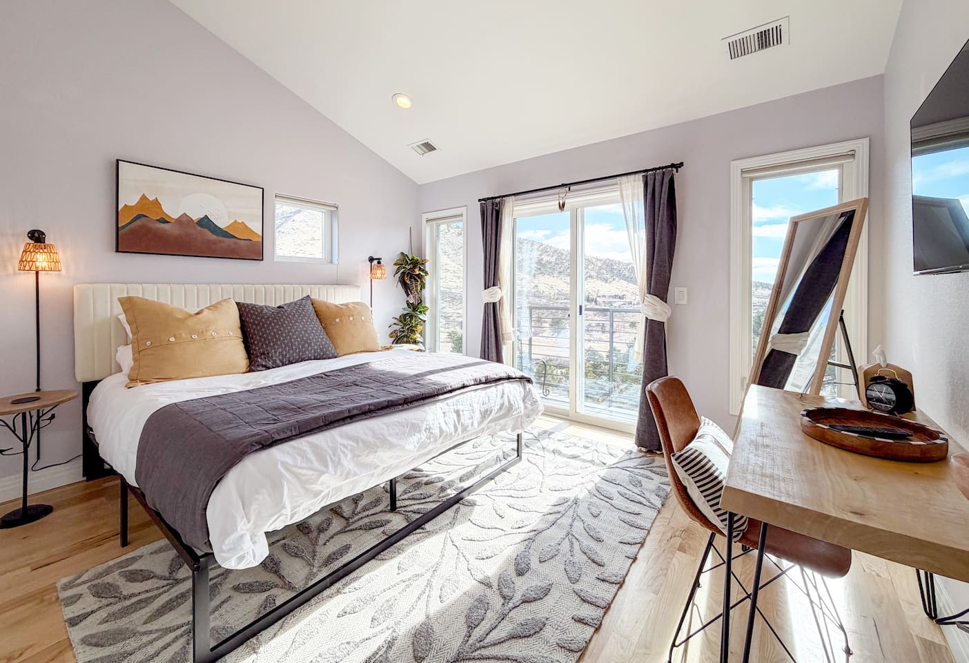 This bright king bedroom is filled with natural light and mountain views, with a private balcony just outside the door—the perfect spot to enjoy a quiet morning coffee or take in the sunset.
