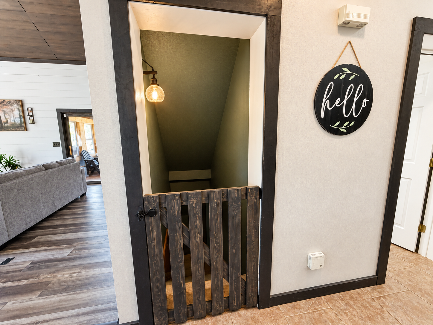 A convenient baby gate just off the kitchen helps keep little ones safe while still keeping the main living areas open, comfortable, and easy for families to enjoy together.
