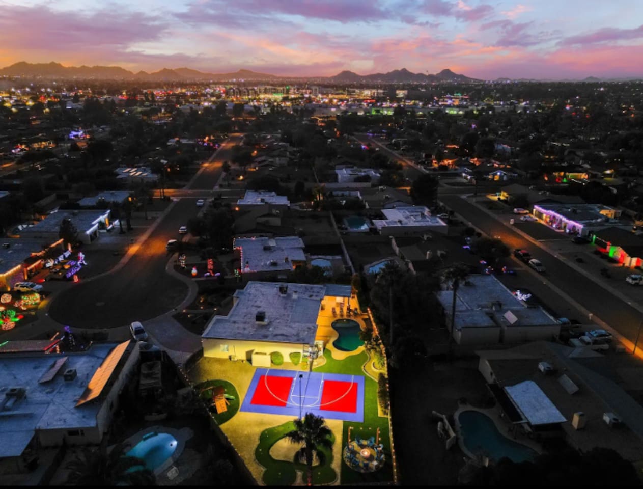 As the sky turns purple, the court lights take over — this backyard doesn't stop when the sun goes down.