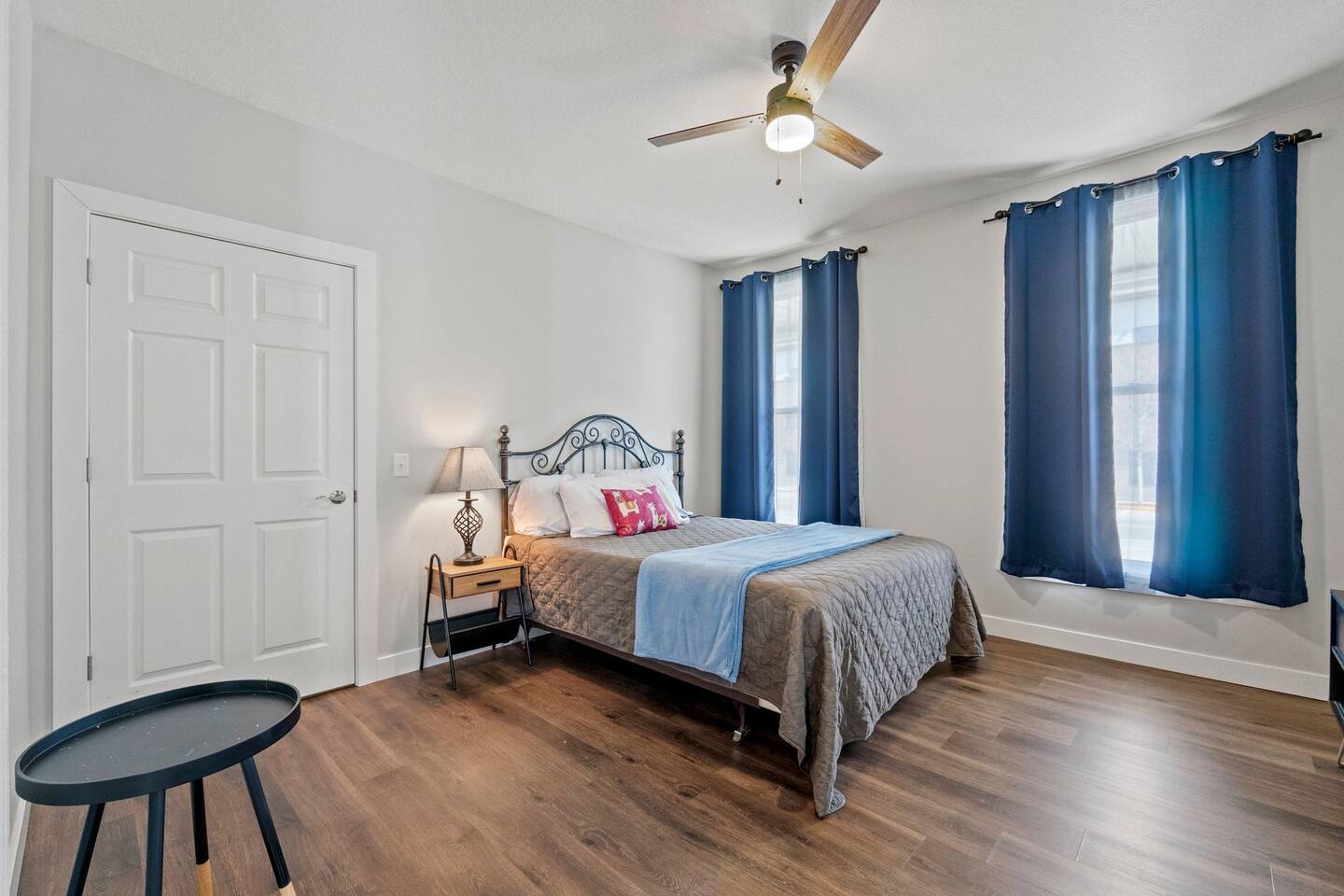 Bright and airy bedroom with two windows, offering plenty of natural light and a peaceful retreat.