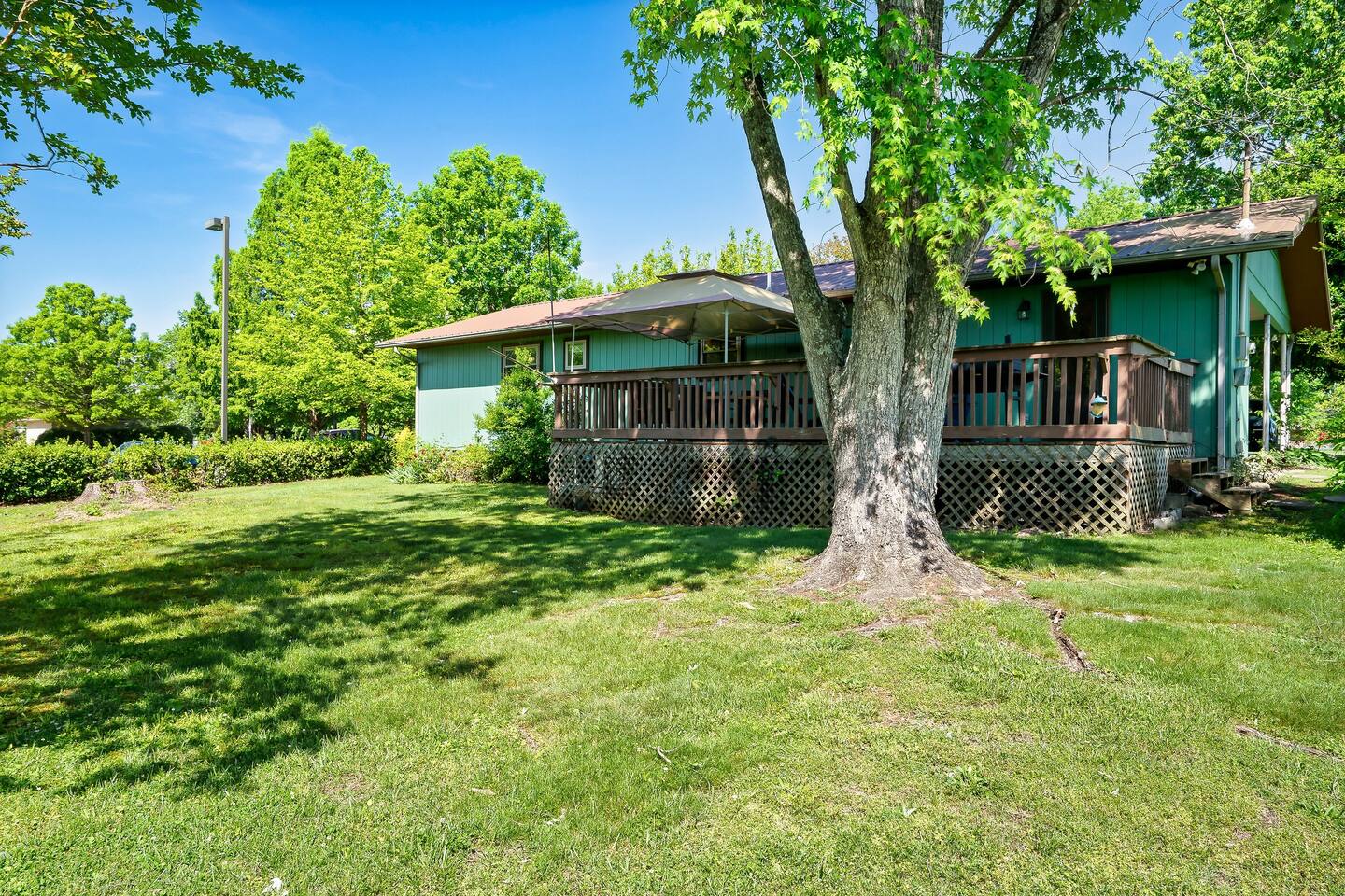 Soak up the warm Tennessee sunshine on the spacious deck, where rocking Adirondack chairs invite you to bask in the beauty of your surroundings. #SunshineAndRelaxation