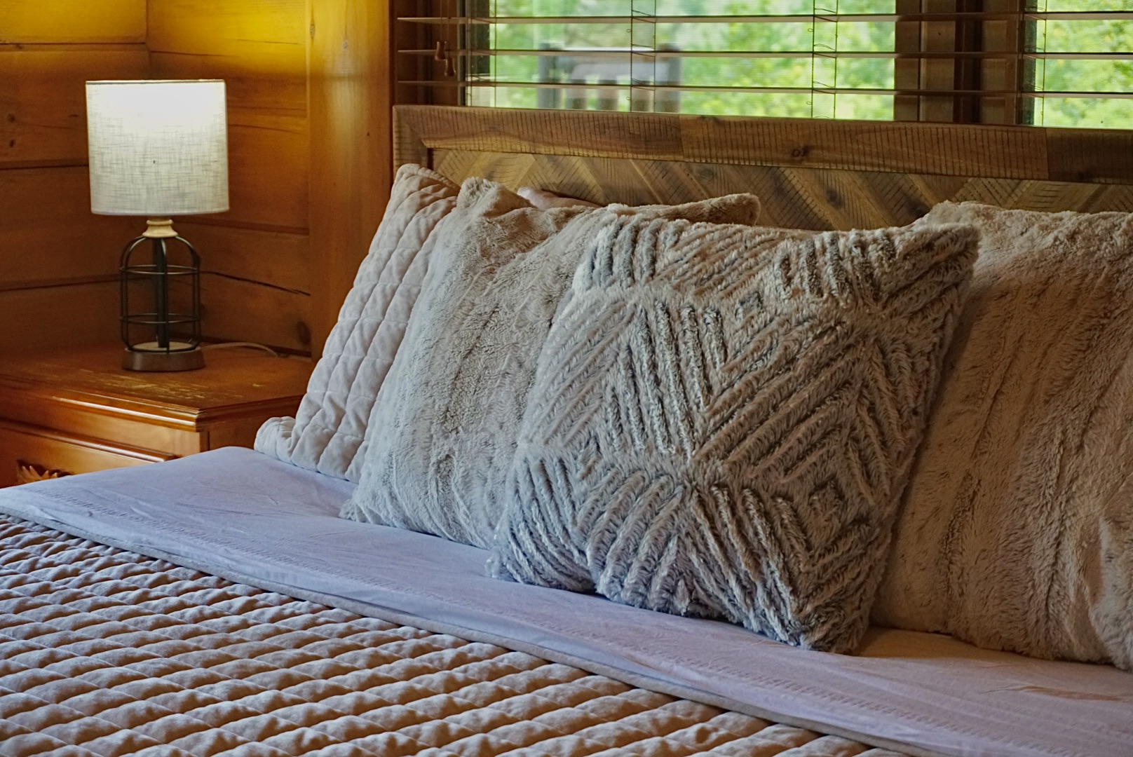 Plush pillows and warm wood create the perfect haven for relaxation and escapism!