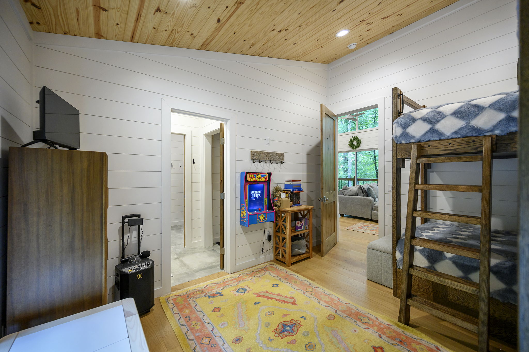 The stylish bunkroom features four twin beds, cozy designer touches, and high-end linens—creating a comfortable and welcoming retreat for kids or additional guests.