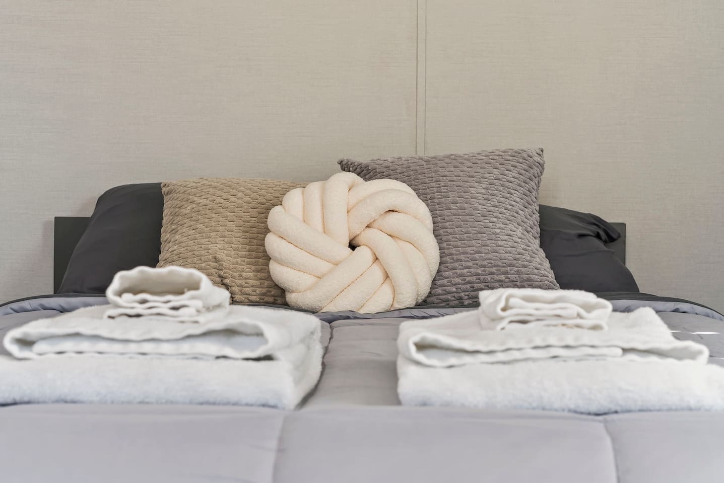 Soft queen bed with fresh linens and cozy accent pillows—perfect for a restful night’s sleep.
